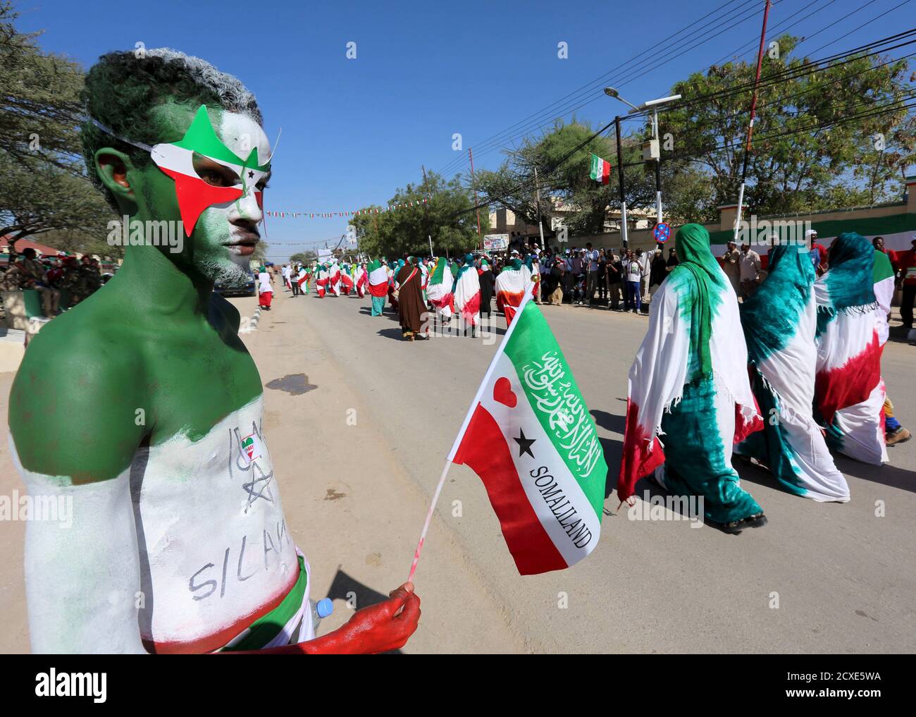 a-man-with-body-paint-in-the-colours-of-the-national-flag-participates-in-a-street-parade-to-c...jpg