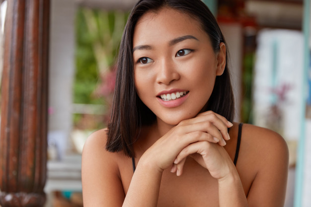 beautiful-chinese-woman-portrait-with-bobbed-hairstyle-poses-cozy-room_273609-2656.jpg