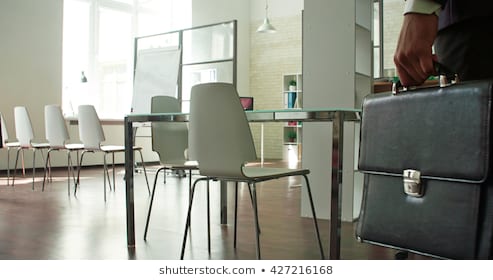 businessman-entering-empty-board-room-260nw-427216168.jpg