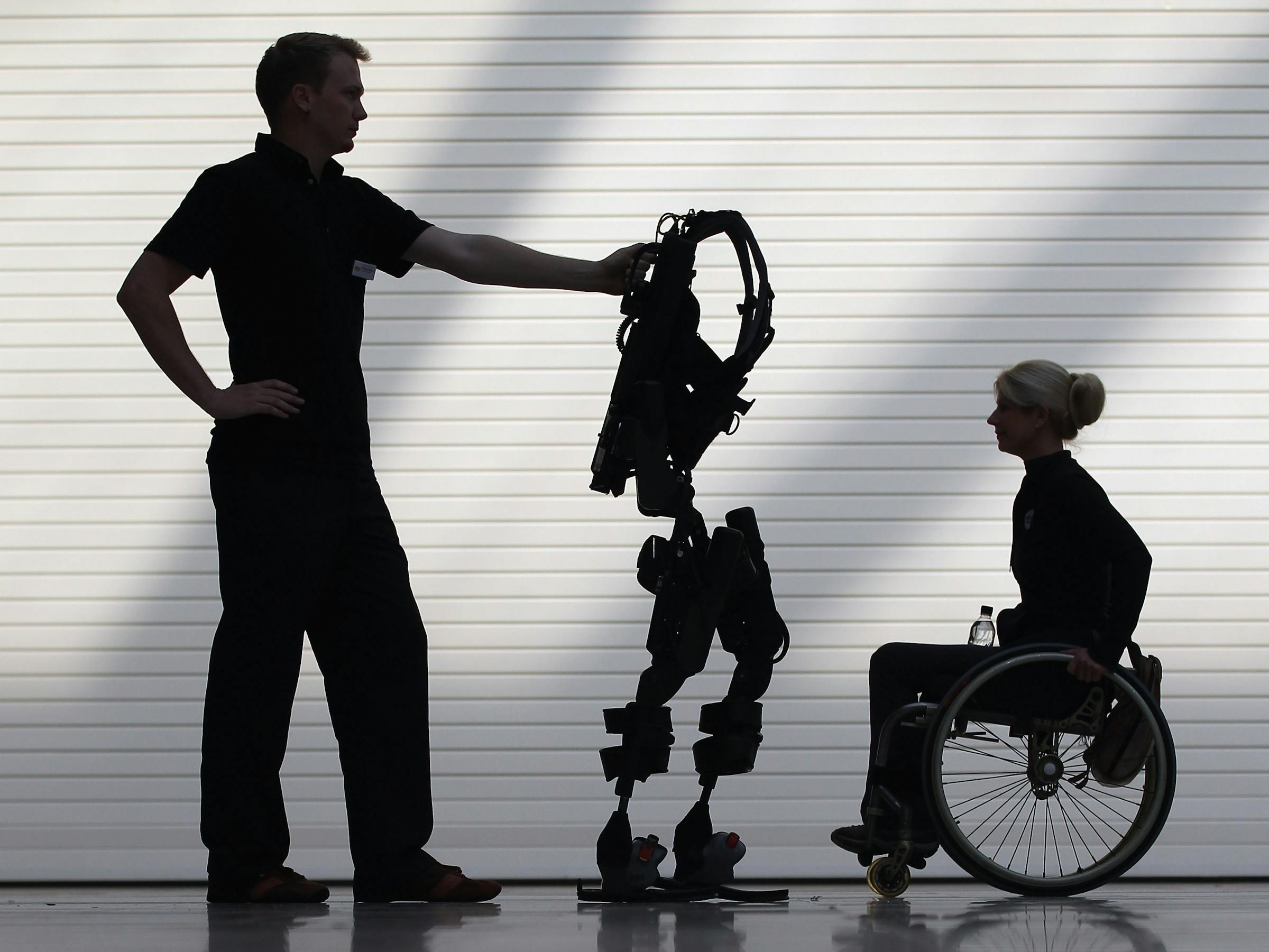london-england---october-21--engineer-thomas-dwyer-stands-with-the-new-bionic-exoskeleton-next-to.jpeg
