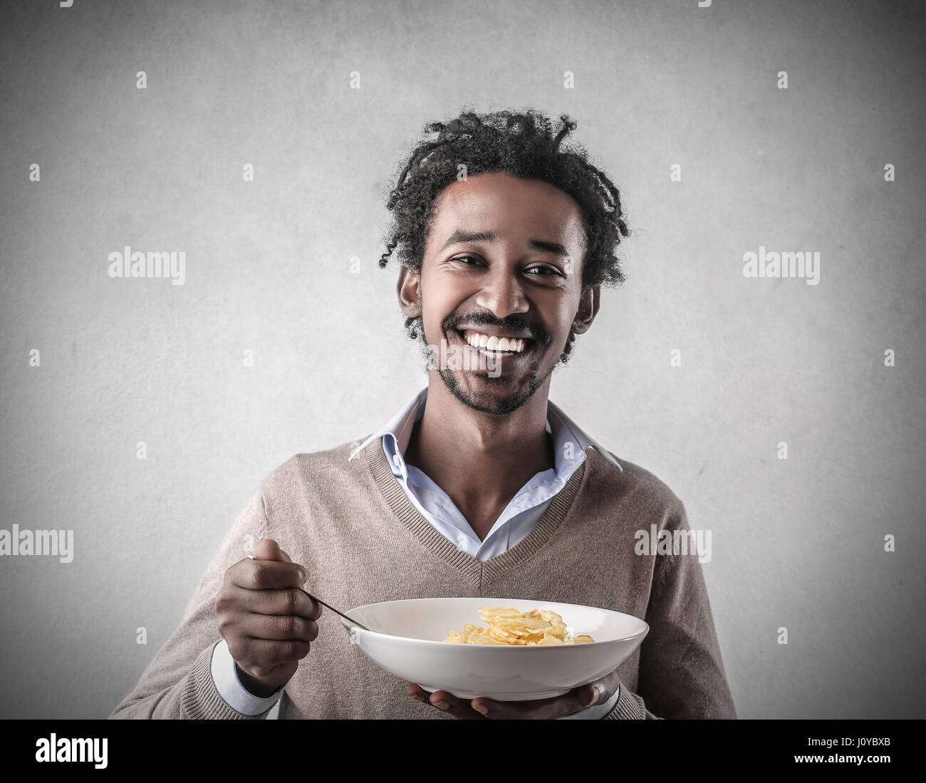 black-man-eating-food-inside-J0YBXB.jpg